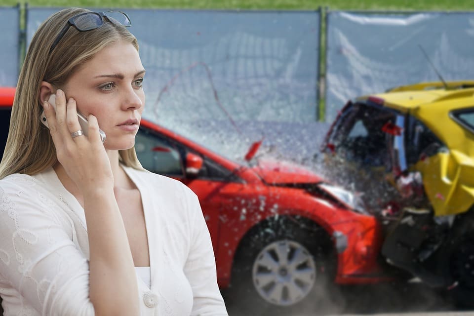 woman using phone after car crash auto accident lawyer in Israel